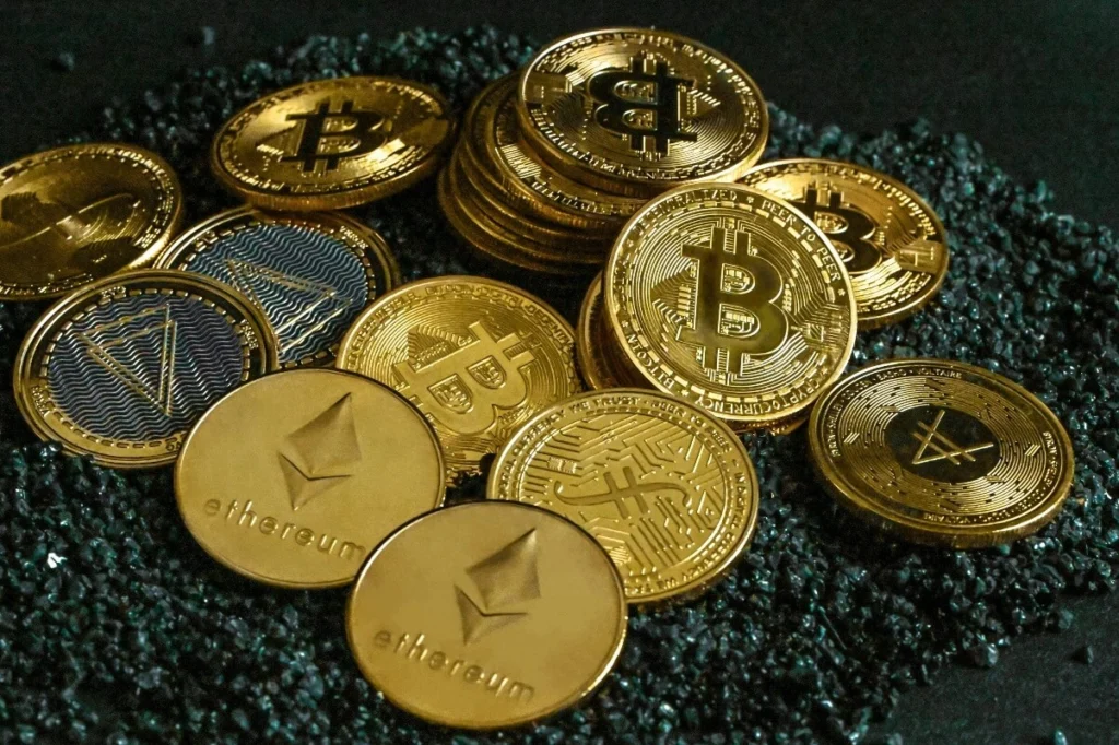 A pile of gold and silver bitcoin-style cryptocurrency coins representing diversified digital asset holdings and market participation